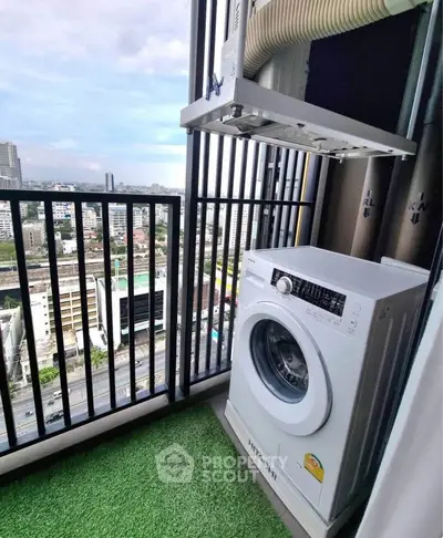 High-rise balcony with washing machine and city view, ideal for urban living.