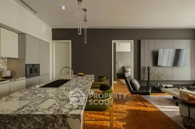 Luxurious open-plan living room with marble kitchen island and modern decor
