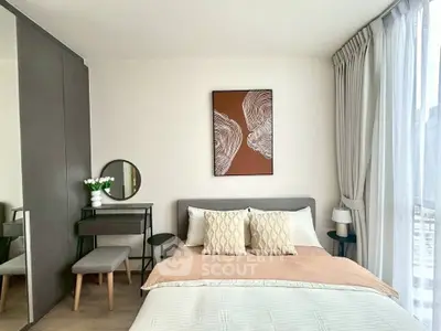 Elegant bedroom with modern decor and large window for natural light