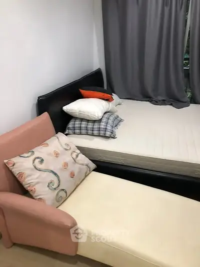 Cozy bedroom with modern decor and comfortable seating area.