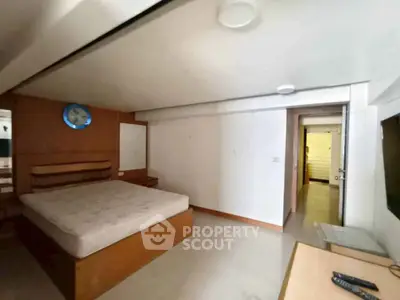 Spacious bedroom with modern design and ample natural light