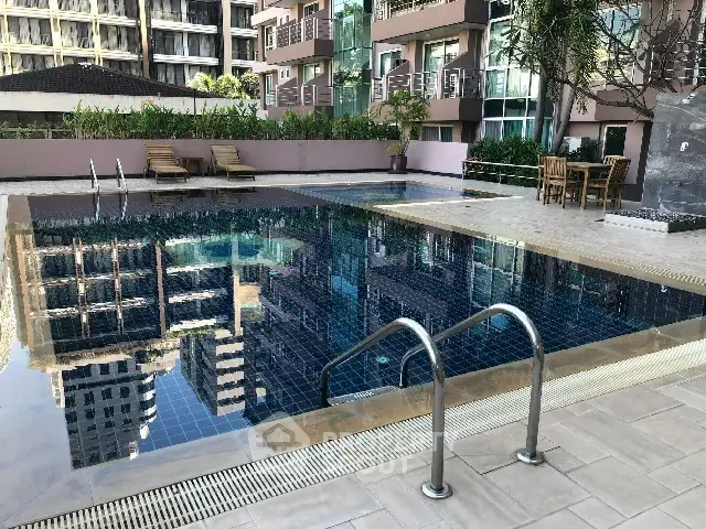 Luxurious residential pool area with modern design and poolside seating.