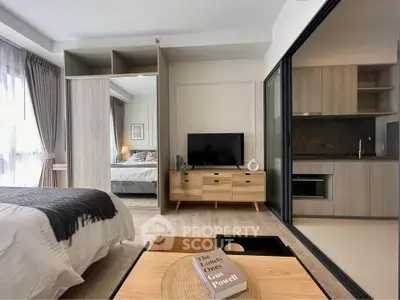 Modern studio apartment with open layout, featuring a cozy bedroom, stylish living area, and sleek kitchen.