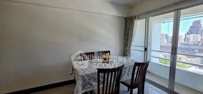 Bright dining area with city view and balcony access in modern apartment.
