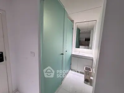 Modern bathroom with frosted glass shower and sleek vanity