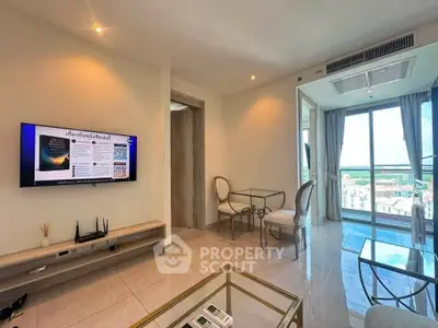 Modern living room with balcony view and stylish furniture in a high-rise apartment.