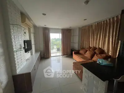 Spacious living room with modern decor and large window view