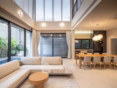 Spacious modern living room with elegant dining area and large windows