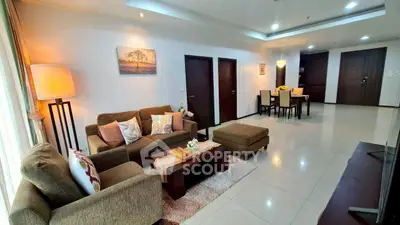 Spacious living room with modern decor and dining area in open layout apartment.