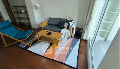 Stylish living room with modern furniture and large window for natural light.