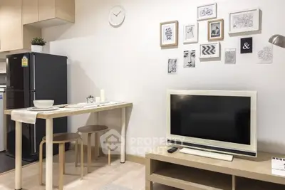 Modern living room with stylish decor, compact dining area, and sleek kitchen appliances in a cozy apartment.