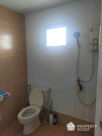 Cozy bathroom with shower and toilet, ideal for compact living spaces.