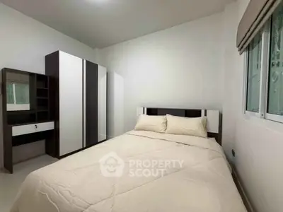 Cozy bedroom with modern furniture and natural light, perfect for relaxation and comfort.