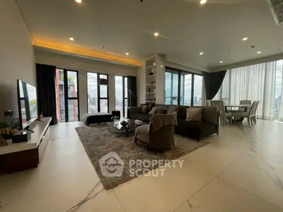 Luxurious corner unit living room with panoramic city views and elegant decor.