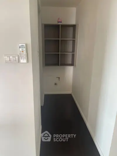 Compact storage area with built-in shelves and utility connections