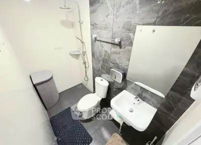 Modern bathroom with sleek fixtures and elegant tile design, featuring a shower and stylish sink area.