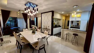 Luxurious open-plan dining and living area with modern lighting and elegant decor.