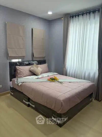 Cozy bedroom with elegant decor and natural light, featuring a comfortable bed and stylish curtains.