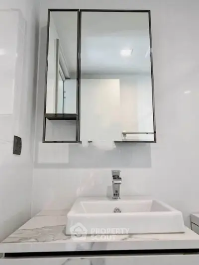 Modern bathroom with sleek mirror cabinet and stylish sink