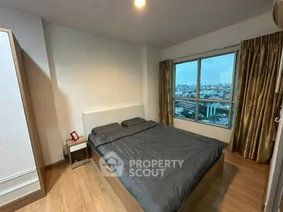 Spacious bedroom with city view and modern furnishings