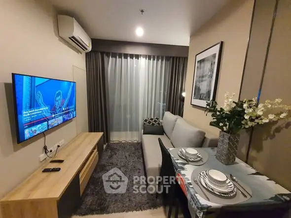 Modern living room with cozy sofa, wall-mounted TV, and elegant dining setup.