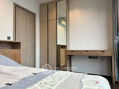 Cozy bedroom with modern wooden furniture and mirrored wardrobe