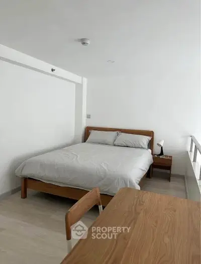 Modern minimalist bedroom with wooden furniture and natural light