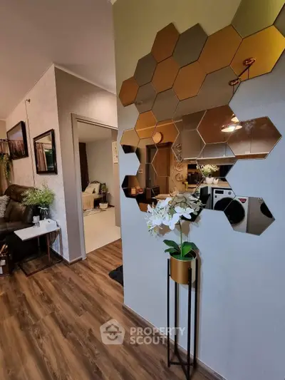 Stylish modern living room with hexagonal mirror decor and elegant wooden flooring