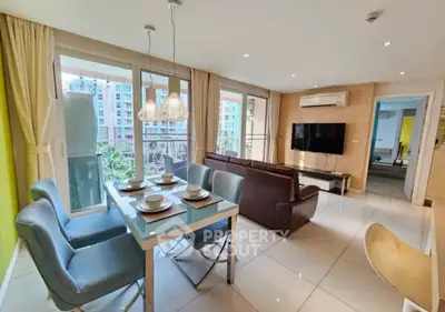 Spacious modern living room with dining area and large windows in a stylish apartment.