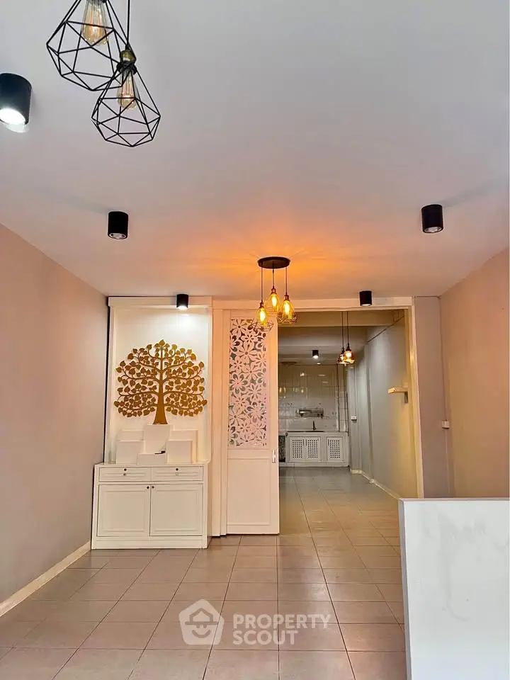Spacious living room with modern lighting and decorative wall art