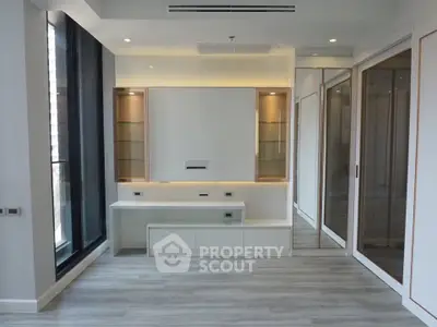 Modern living room with sleek built-in cabinets and large windows