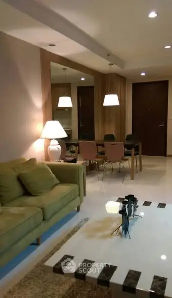 Elegant living room with modern decor and cozy dining area, perfect for entertaining guests.