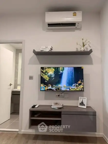 Modern living room with wall-mounted TV and air conditioning unit