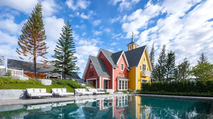 Charming colorful house with a stunning pool and lush greenery, perfect for serene living.