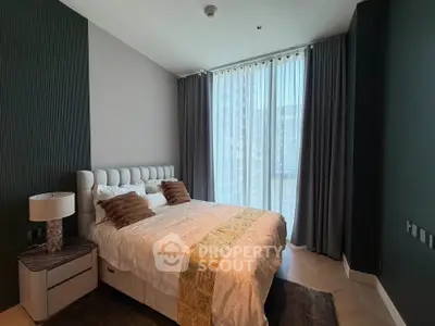 Modern bedroom with elegant decor and large window in luxury apartment