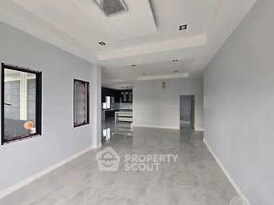 Spacious open-plan living area with modern finishes and large windows.