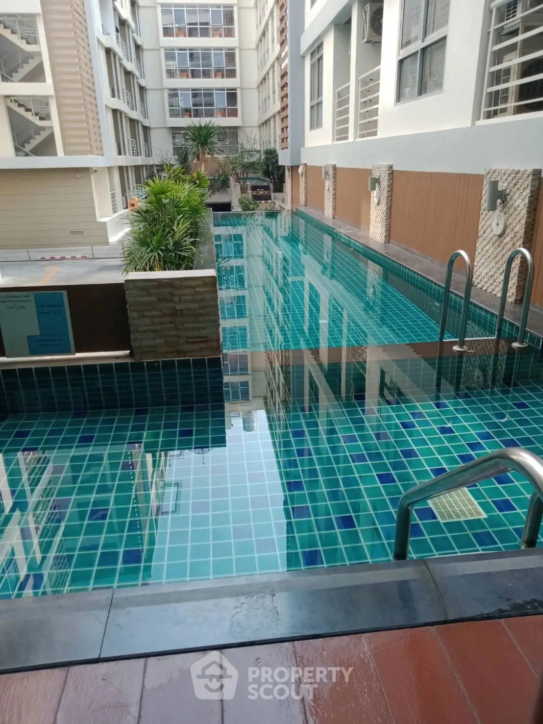 Luxurious condominium pool with modern design and city view