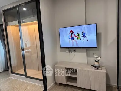 Modern living room with wall-mounted TV and stylish wooden cabinet