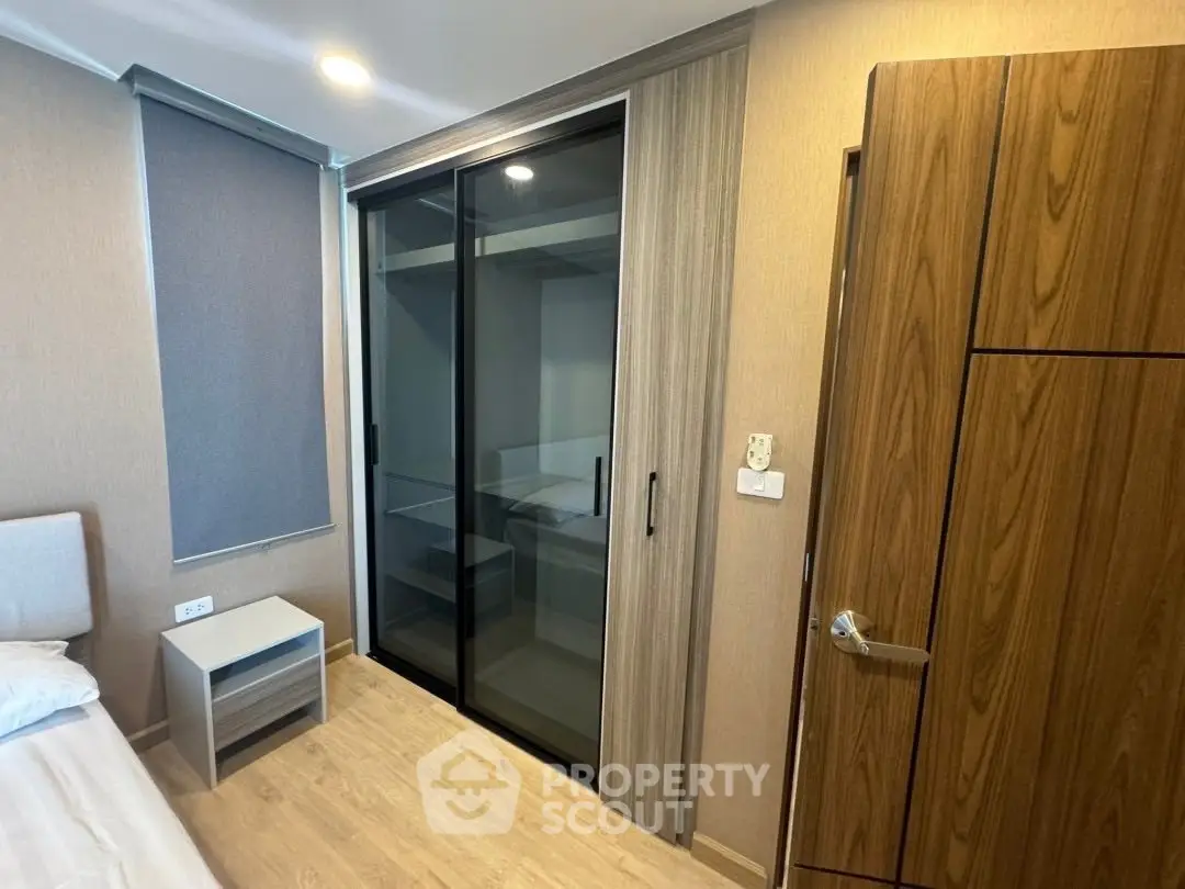 Modern bedroom with sleek sliding closet doors and minimalist design