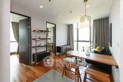 Modern living room with stylish furniture and large windows offering natural light.