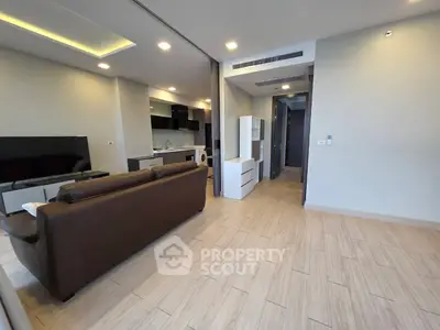 Modern living room with open kitchen and stylish furniture in a contemporary apartment.