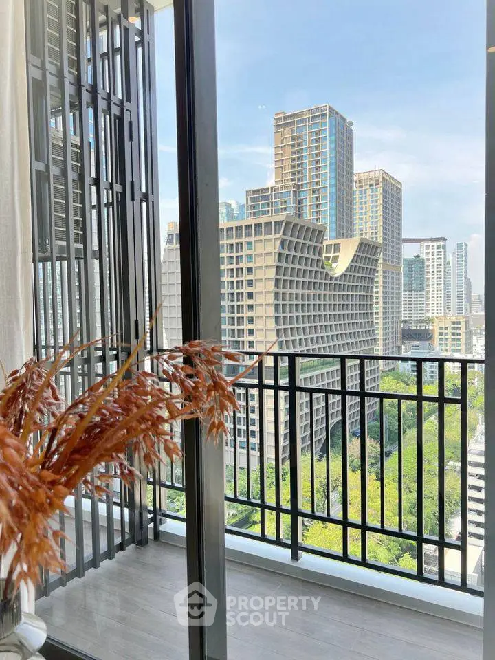 Stunning city view from modern balcony with sleek railing and lush greenery.