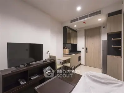 Modern apartment interior with sleek kitchen and cozy living area, perfect for urban living.