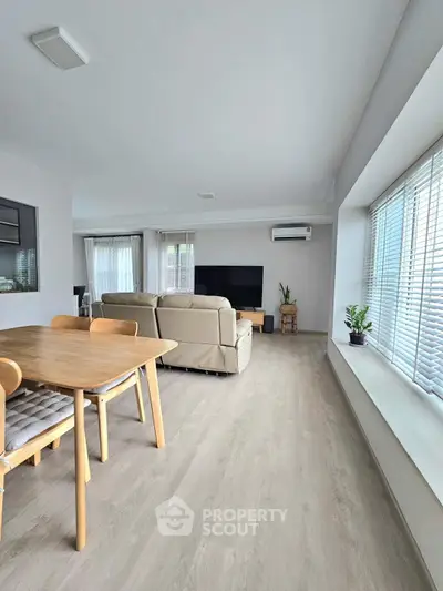 Spacious modern living room with natural light and stylish furniture