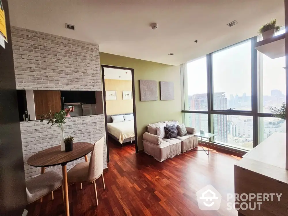 Modern living room with city view, hardwood floors, and stylish decor