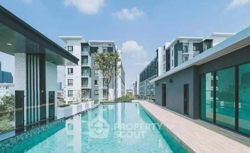 Luxurious rooftop pool with stunning city views in modern apartment complex.