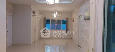 Spacious living room with elegant lighting and large window view