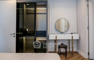 Modern bedroom with sleek wardrobe and stylish vanity in a contemporary apartment.