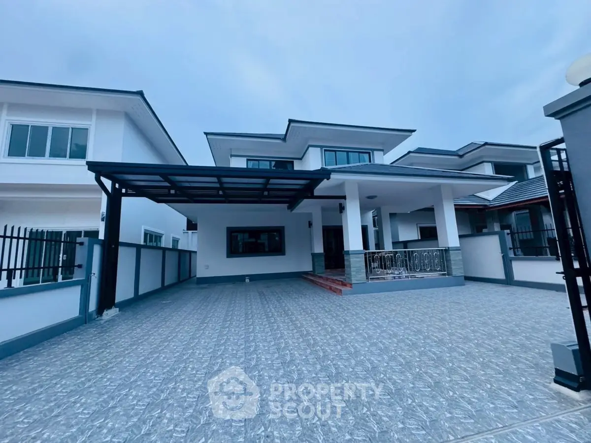 Modern two-story house with spacious driveway and sleek design