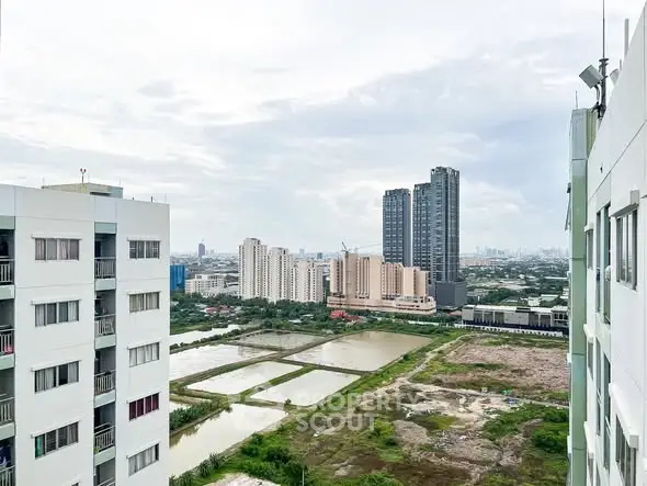 Stunning cityscape view from high-rise building with lush greenery and modern architecture.